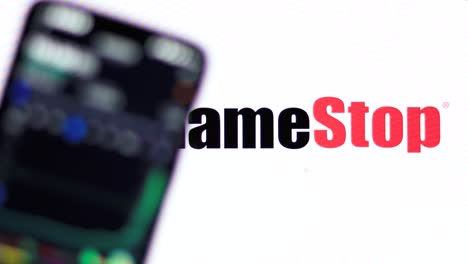 GameStop-stock-price-displayed-on-the-smartphone-against-gamestop-logo-in-the-background-with-rackfocus
