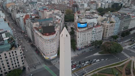 Aerial-pan-right-of-Obelisk-monument-in-9-de-Julio-and-Corrientes-avenue-intersection,-Buenos-Aires