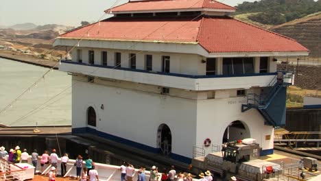 Cruise-ship-slowly-being-pulled-out-of-the-Pedro-Miguel-Locks,-transiting-Panama-Canal