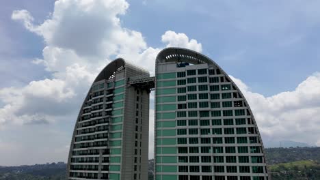 Top-connecting-platform-at-Maj-Meliá-Bandung-Dago-Spa-Hotel-on-cloudy-day,-Aerial-orbit-left-shot