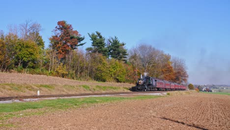 An-Antique-Restored-Steam-Train-Approaching-with-Smoke-and-Steam-on-a-Sunny-Fall-Day