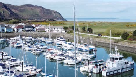 Luxury-yachts-and-sailboats-mooring-in-Conwy-Wales-colourful-sunny-mountain-marina-Aerial-view