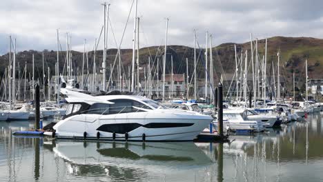Speedboat-moored-under-luxury-Conwy-mountainous-marina-waterfront-North-Wales