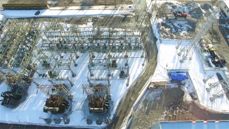 Electric-transformer-building-in-winter,-aerial-drone-view