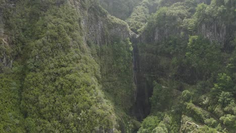 Wide-and-epic-aerial-shot-moving-forwards-towards-Lagoa-da-Vento-waterfall-in-Madeira