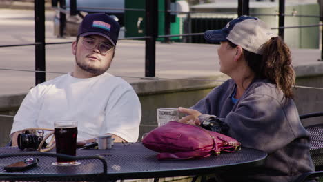 Couple-talking-at-a-table-during-Dogwood-Festival,-Siloam-Springs,-Arkansas