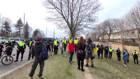 Police-officers-blocking-protestors-by-forming-a-line-in-Mississauga,-Canada