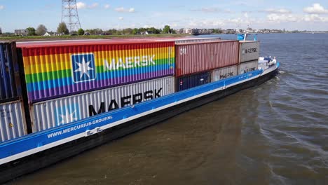 Große-Maersk-Container-Im-Frachtschiff-Von-Mercur-Fahren-Im-Dorf-Kinderdijk-In-Molenlanden,-Südholland,-Auf-Dem-Wasser