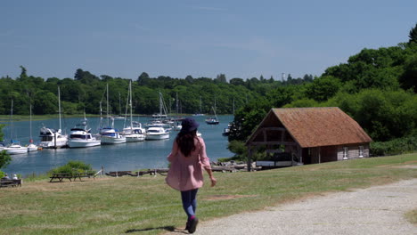 An-Indian-female-tourist-enjoying-at-Buckler's-Hard,-New-Forest,-Hampshire,-England,-UK