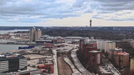 Aerial-view-of-Frihamnen-area-of-Stockholm-with-majestic-city-skyline-in-horizon