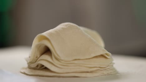 Professional-chef-neatly-stacks-prepared-dumpling-dough