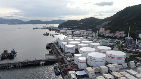 Hong-Kong-commercial-Port,-aerial-approach-passing-above-Oil-and-Chemical-storage-depot