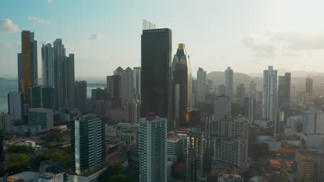 Drone-Flying-Towards-Towerbank-And-Evolution-Tower-Skyscrapers-In-Panama-City,-Panama