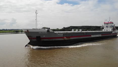 Aerial-Tracking-View-Of-Delfborg-General-Cargo-Ship-On-Oude-Maas-Near-Barendrecht