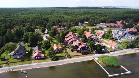 Vibrant-and-colorful-town-of-Pervalka-on-sunny-day,-aerial-orbit-view