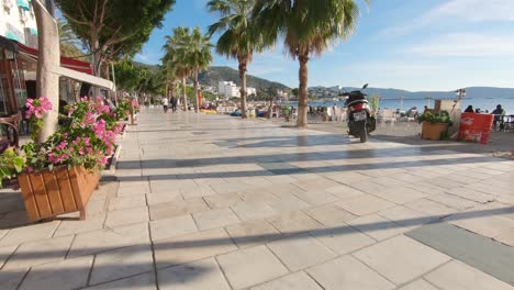 Dolly-in-tilting-shot-showing-beautiful-tranquil-Bodrum-Beach-Promenade-on-a-sunny-day-in-summer