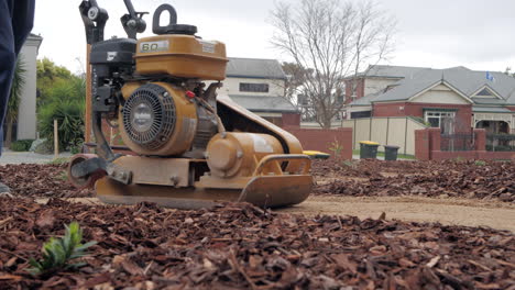 CLOSE-UP-Path-Garden-Compactor-Flattens-Rocky-Stones-Into-Ground