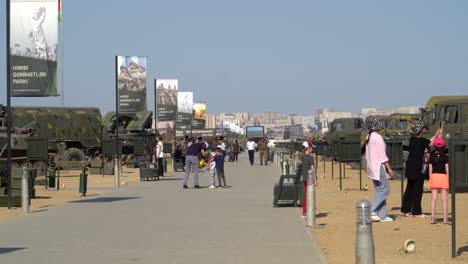 Azerbaijani-families-enjoy-the-displays-of-captured-Armenian-equipment-in-Trophy-park,-Baku,-Azerbaijan