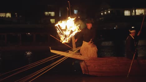 Ukai-Fishing-Master-holding-ropes-attached-to-Cormorants-at-night