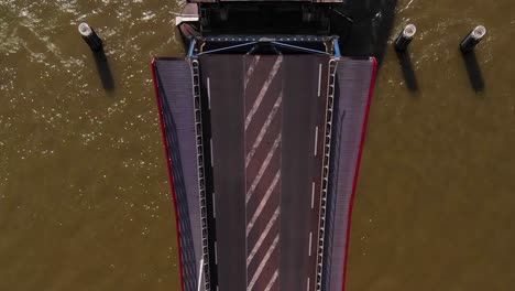 Aerial-View-Looking-Down-At-Road-Bridge-Opening-Over-River-Noord