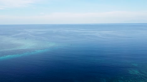 Aerial-drone-rising-over-stunning-coral-reef-ecosystem-on-the-coral-triangle-overlooking-pristine-blue-ocean-in-Timor-Leste,-Southeast-Asia