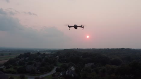 Aerial-of-drone-flying-toward-sunset