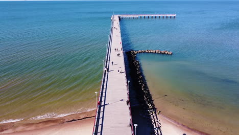 Almost-empty-bridge-of-Palanga-on-sunny-day,-aerial-flying-over-shot