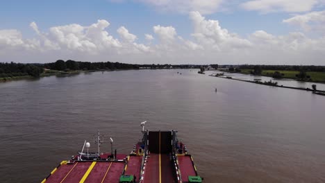 Dynamica-Barge-Transporting-Navigating-Oude-Maas-Lorries-And-Tractors-Going-Past-On-Oude-Maas