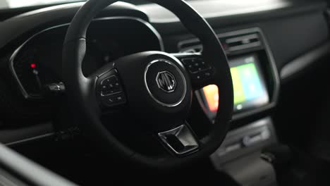 modern-car-steering-wheel-with-lighted-display-and-morris-garages-logo