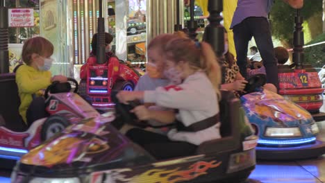 children-have-fun-in-the-electric-bumper-car-toy-at-the-amusement-park-in-Lugo,-Spain