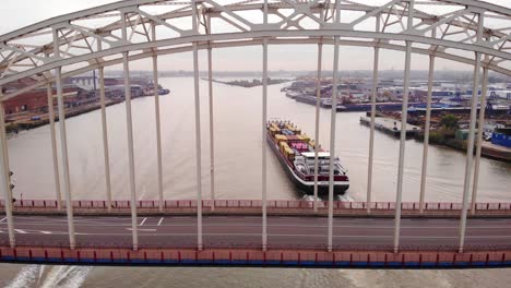 Aerial-View-Through-Bridge-Over-The-Noord-Of-Bolero-Cargo-Ship-Passing-By-Near-Hendrik-Ido-Ambacht