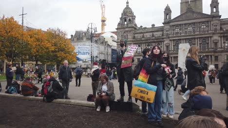 A-group-of-protesters-sitting-down-for-a-rest-in-George-Square,-Glasgow