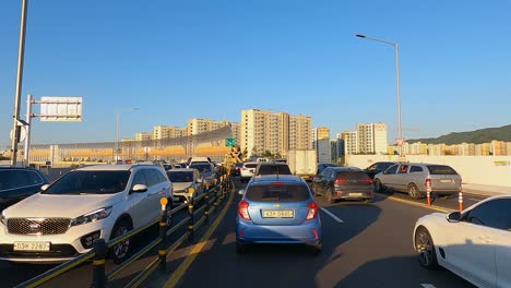 Seoul---cars-stuck-in-a-traffic-jam-in-highway-at-sunset-busy-hour-on-the-way-back-from-office---driver's-POV