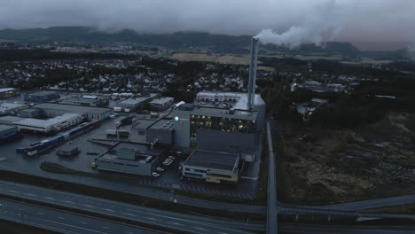 Trondheim-District-Heating-Plant,-Statkraft,-With-Dark-Cloudy-Sky-In-Norway---aerial-shot