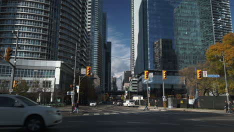 Tilt-down-from-buildings-to-street-traffic-at-Queens-Quay-in-Toronto