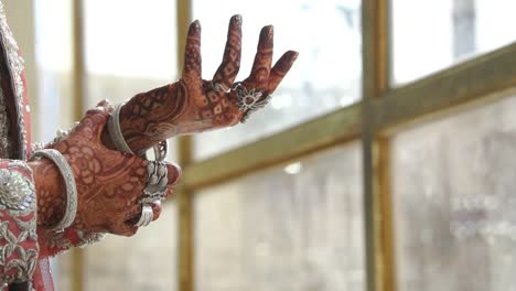 Asian-Bride-Being-Playful-With-Silver-Bangles-Near-Bokeh-Window