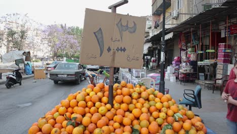 Vibrant-pile-of-oranges-in-street-market-location-in-Tripoli,-Lebanon