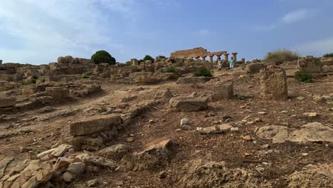 Moving-footage-of-people-visiting-Selinunte-archaeological-park-with-ancient-Greek-temple-in-Sicily,-Italy