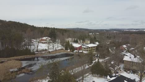 Drone-Shot-Of-Old-Historic-Alton-Mill-Art-Centre-Covered-In-Snow-During-Winter