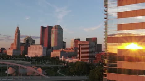 Aerial-view-of-Columbus-city-center-during-summer-sunset---pan,-drone-shot