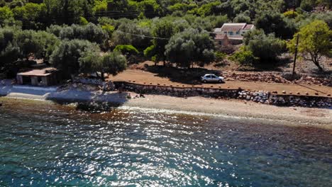 Aerial-View-Of-Seascape-On-A-Sunny-Day-At-Agia-Sofia-Beach-In-Greece---drone-shot