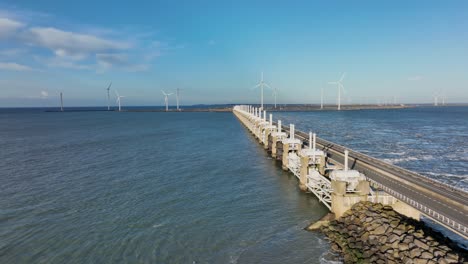 Aerial-shot-of-the-end-of-the-Eastern-Scheldt-storm-surge-barrier-in-Zeeland,-the-Netherlands,-on-a-beautiful-sunny-day