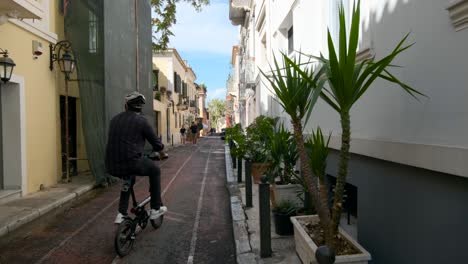 People-ride-bicycle-ouside-in-alley-at-Plaka-district