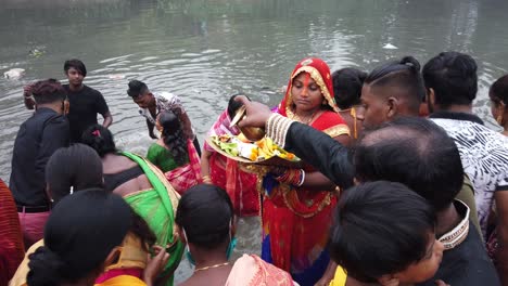 Shot-of-an-Indian-women-standing-near-the-ganga-river-water-with-Hindu-ritual-items-for-Indian-wedding-ceremony-in-Kolkata