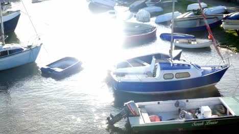 Looking-down-waterfront-boats-on-shimmering-picturesque-holiday-marina-water