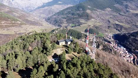 Aerial-shot-orbiting-a-historic-church-on-a-mountain-in-Catalonia,-Spain