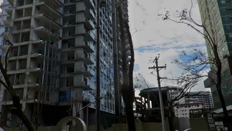 In-the-aftermath-of-typhoon-Odette-,-a-few-cleared-streets-that-became-passable-would-show-denuded-trees-and-much-architectural-damage-on-buildings