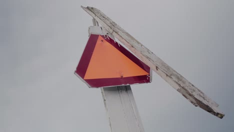 Interesting-LGF-Sign-On-Top-of-Wooden-Plank-With-Propeller-On-A-Cloudy-Autumn-Day-In-Vårhallarna-Skåne-Sweden---Handheld-Low-Angle-Medium-Shot