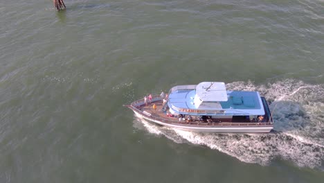Aerial-view-of-boat-moving-fast-in-middle-of-the-ocean-|-Drone-shot-of-a-tourist-boat-moving-in-middle-of-the-ocean-video-background-in-4K