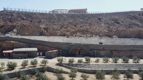 Aerial-view-of-the-entrance-to-the-Zaytouna-Farm,-Saudi-Arabia---reverse,-drone-shot